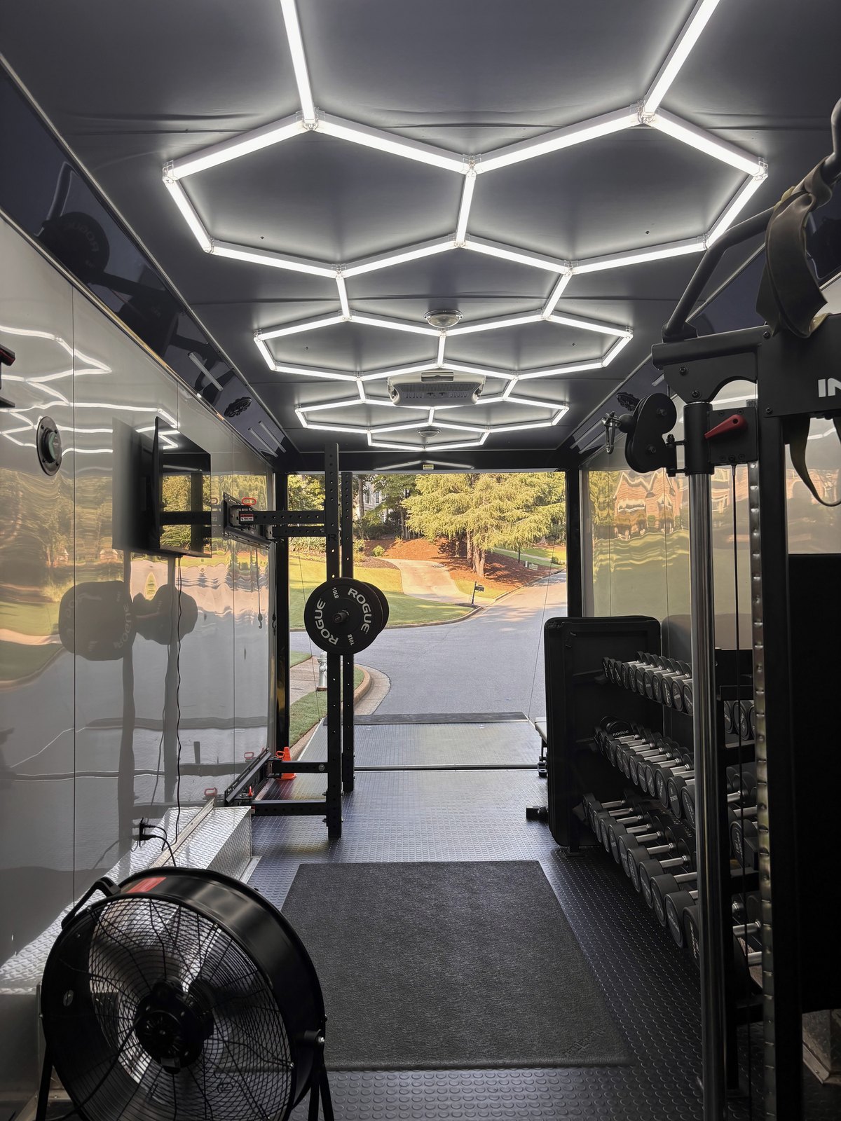 Inside the mobile gym, looking out through the open door to a residential street