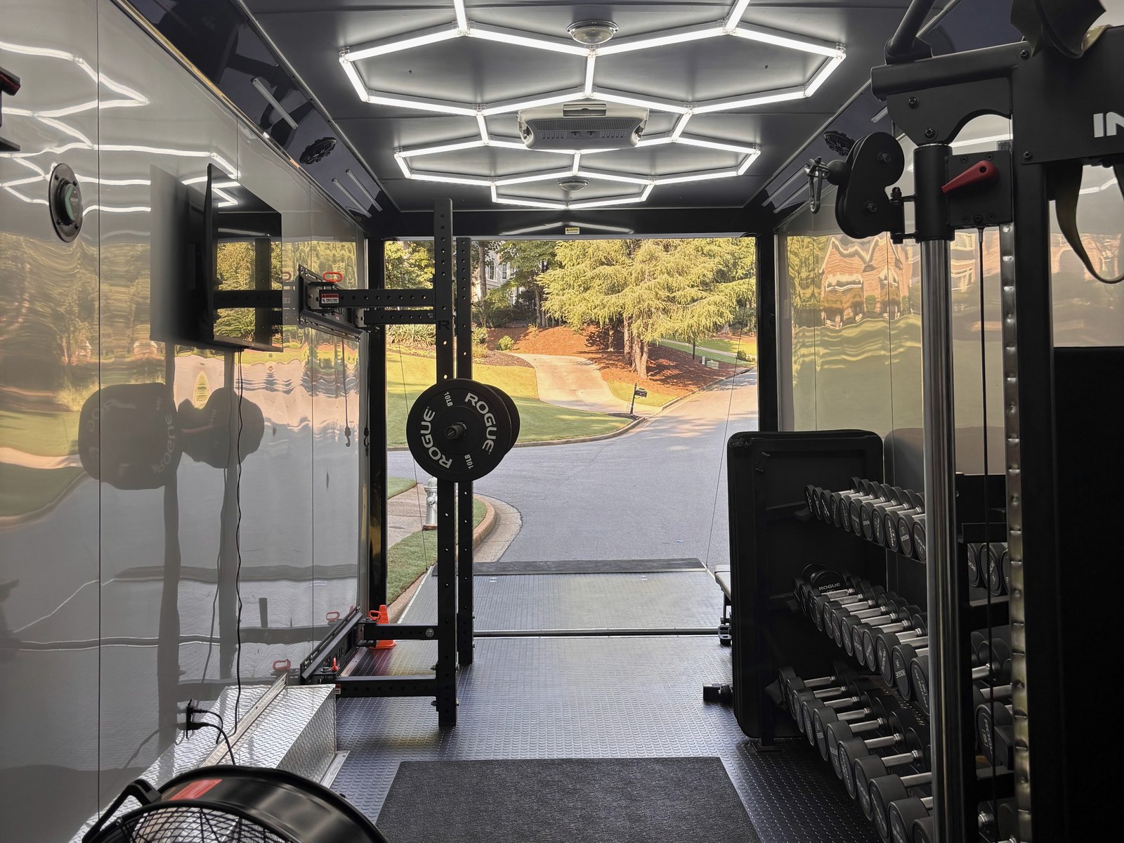 Inside the mobile gym, looking out through the open door to a residential street